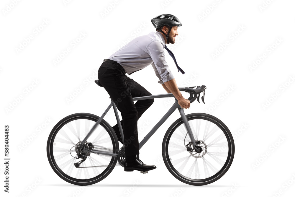 Naklejka premium Profile shot of a businessman riding a bicycle with a helmet