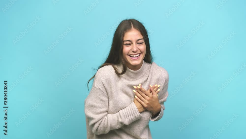 Young caucasian woman laughing keeping hands on heart, concept of happiness Young caucasian woman laughing keeping hands on heart, concept of happiness
