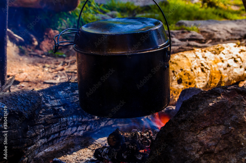 fire burns in the campaign. pot of tea by the fire. fire burns in the campaign. pot of tea by the fire.