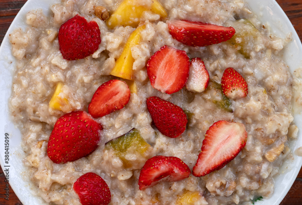 Oatmeal with strawberries, peaches and other fruits. Healthy breakfast. Oatmeal with strawberries, peaches and other fruits. Healthy breakfast.
