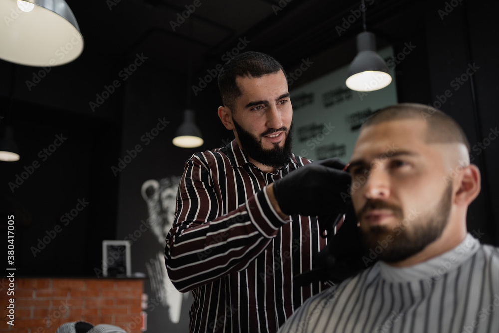 stylish men's haircut in barbershop short hair brunette Caucasian  appearance. Beard and mustache on the face. Dark interior of the barbershop  Stock Photo | Adobe Stock