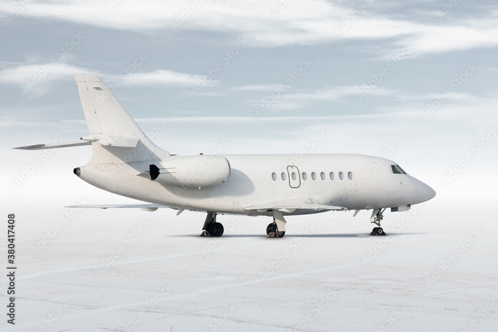Obraz premium Modern white corporate business jet isolated on light background with sky