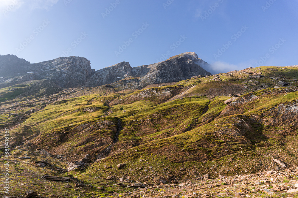 The glaciers, mountains and meadows of the alta val formazza at dawn, during a summer day, near the town of Riale, Italy - July 2020.