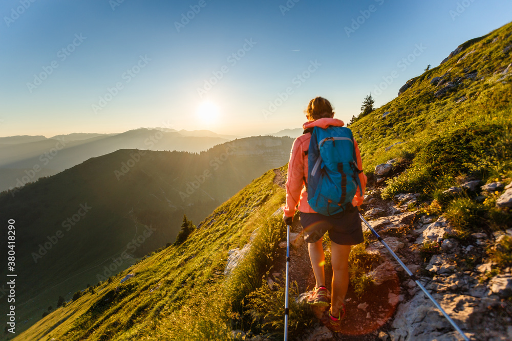 Hiker walking in the mountain at sunset