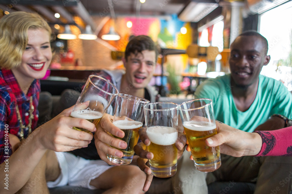 Group of attractive young people toasting with beer glasses Group of attractive young people toasting with beer glasses