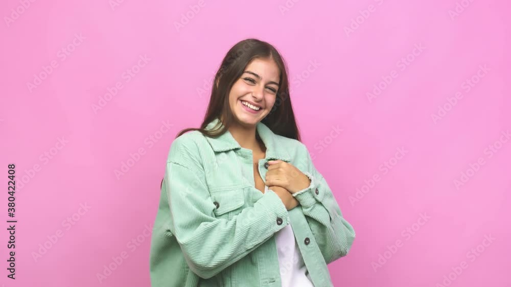 Young caucasian woman has friendly expression, pressing palm to chest love concept Young caucasian woman has friendly expression, pressing palm to chest love concept