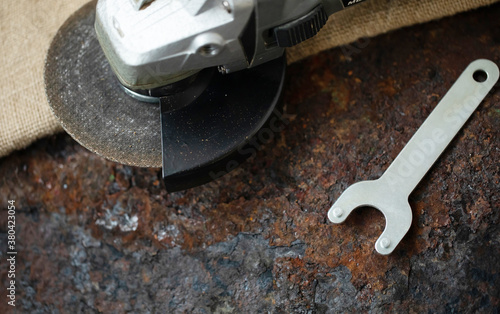 Angle grinder on metal on iron background.