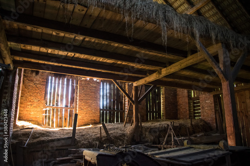 Old dilapidated barn of wood and brick in the village