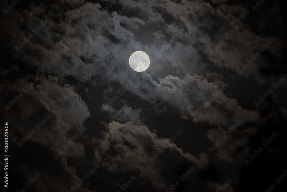 Background with night cloudy sky and full moon. Halloween Spooky night.