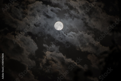 Background with night cloudy sky and full moon. Halloween Spooky night.