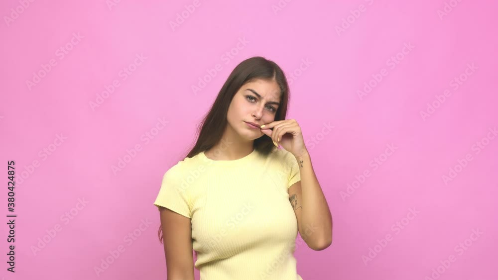 Young caucasian woman with fingers on lips keeping a secret Young caucasian woman with fingers on lips keeping a secret