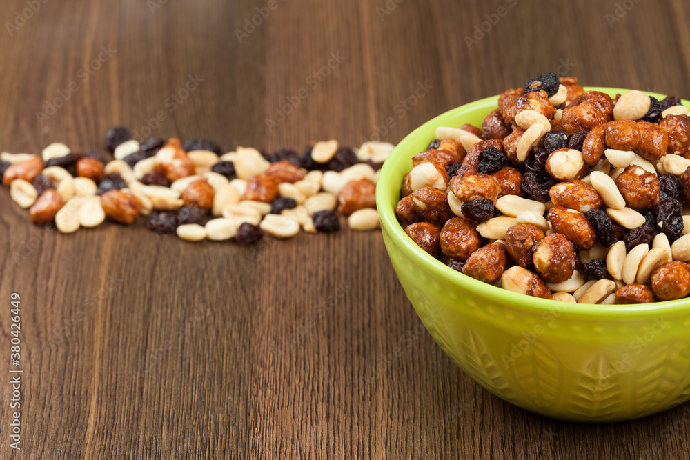 Healthy And Tasty Snack; Mixture of peanuts, raisins, and peanuts Covered With Honey. Healthy And Tasty Snack; Mixture of peanuts, raisins, and peanuts Covered With Honey.