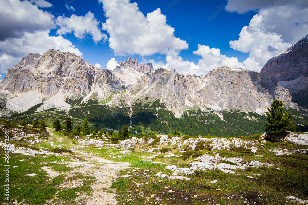 summer mountain landscape with blue sky and clouds, dolomites, italy