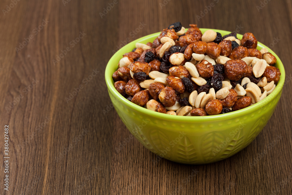 Healthy And Tasty Snack; Mixture of peanuts, raisins, and peanuts Covered With Honey. Healthy And Tasty Snack; Mixture of peanuts, raisins, and peanuts Covered With Honey.