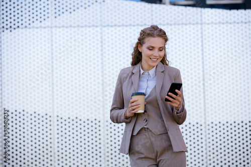 Young businesswoman in glasses is messaging on the smartphone