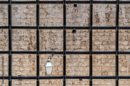 Dubrovnik: Lamp on the wall behind bars