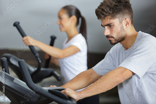 determined young man exercising in the gym