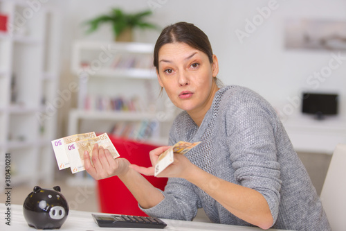Vászonkép portrait of woman saving money