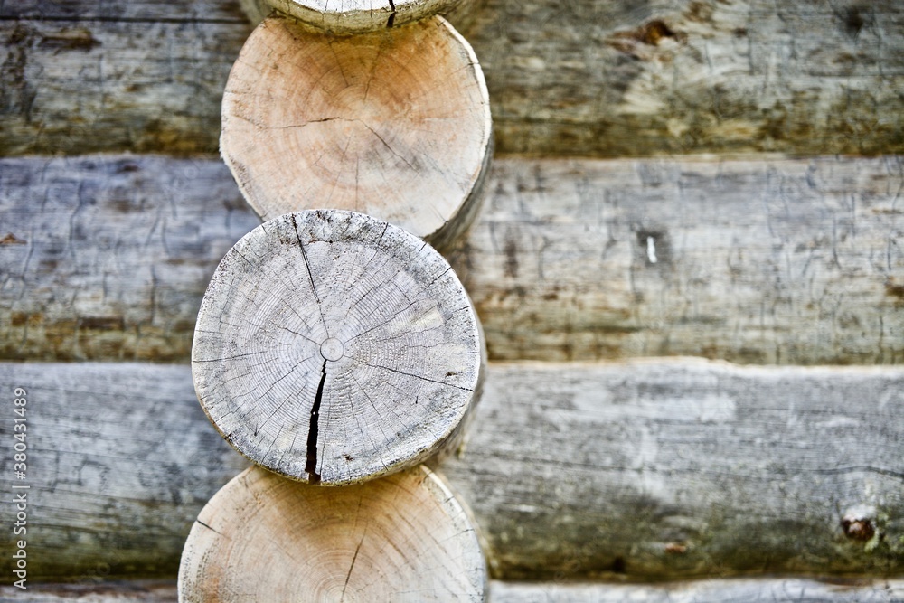 The Frame of the wooden log house close up. Log cabin walls made from an arctic pine. The walls of the log house made from Kelo. Saw cut of an arctic pine trunk close-up. Tree rings texture close up. The Frame of the wooden log house close up. Log cabin walls made from an arctic pine. The walls of the log house made from Kelo. Saw cut of an arctic pine trunk close-up. Tree rings texture close up.