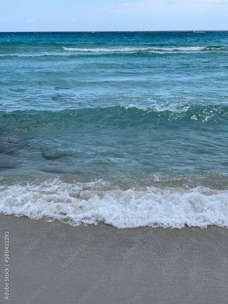 Blue and lazur aquamarine waves on the sand beach in Aiya Napa in Cyprus 