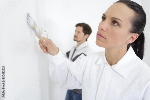 woman painter painting a wall