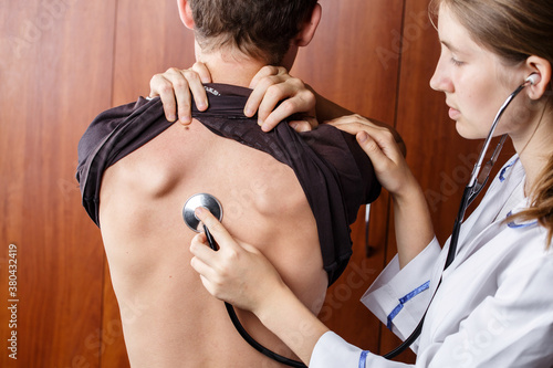 doctor listening to the patients breathing