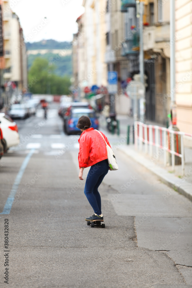 Cool woman driving a skateboard in the street Cool woman driving a skateboard in the street