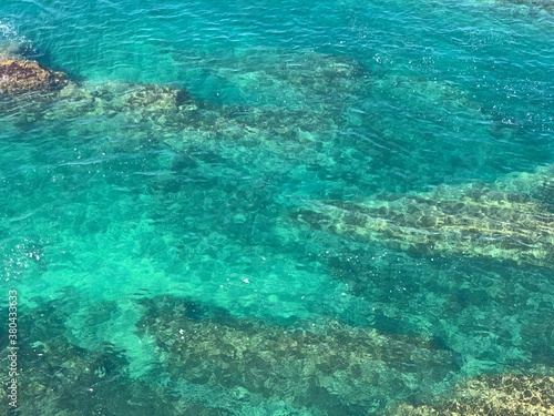 Beautiful aquamarine color of sea water. Adriatic sea background. Blue freshness. Underwater world. Stones and seaweed. Turquoise surface of waters. Amazing marine.