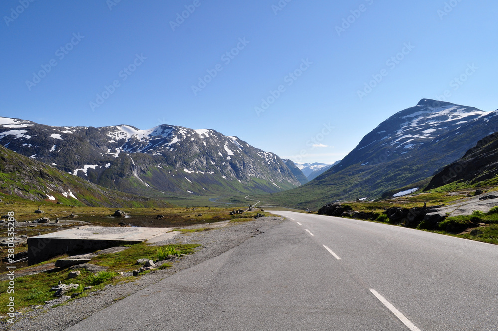 Fototapeta premium Road leading in a valley between mountains in Norway