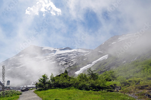 High rocky mountains shrouded in clouds, Troll road, Norway