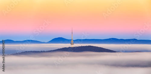 Canberra tower over the autumn fog