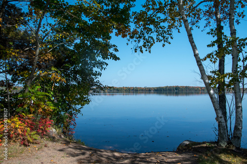 Welcoming lakeside beach surrounded by autumn colors