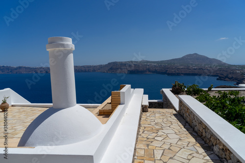 Beautiful view from Akrotiri to caldera and volcano on a sunny day. landscape format. Santorini island, Cyclades, Greece, Europe. photo