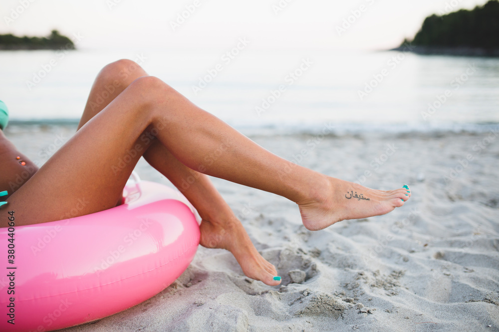 Woman sitting on an inflatable tube on the beach Woman sitting on an inflatable tube on the beach