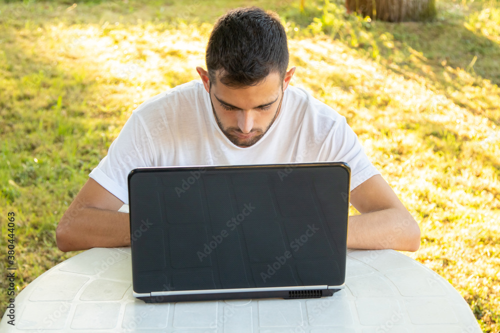 man teleworking with computer on outdoor terrace man teleworking with computer on outdoor terrace