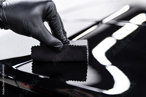 Man car detailing studio worker applying ceramic coating © Daniel Jędzura