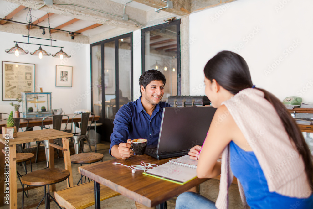 Two friends studying together in a coffee shop Two friends studying together in a coffee shop