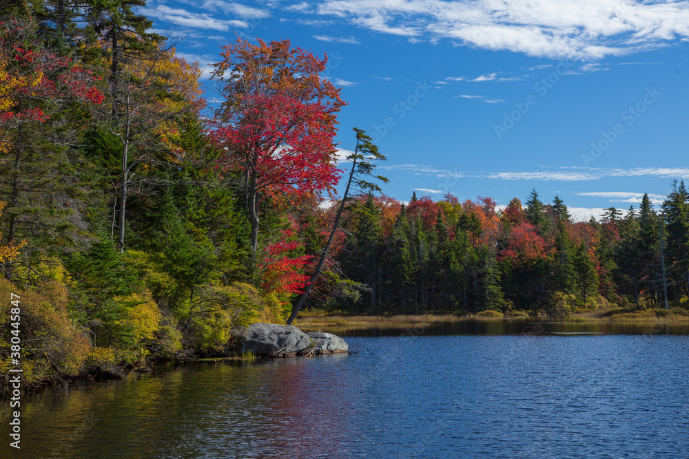 Red and yellow autumn colors are reflected in Adams reservoir, along the Molly Stark Trail, near Woodford vermont. Red and yellow autumn colors are reflected in Adams reservoir, along the Molly Stark Trail, near Woodford vermont.