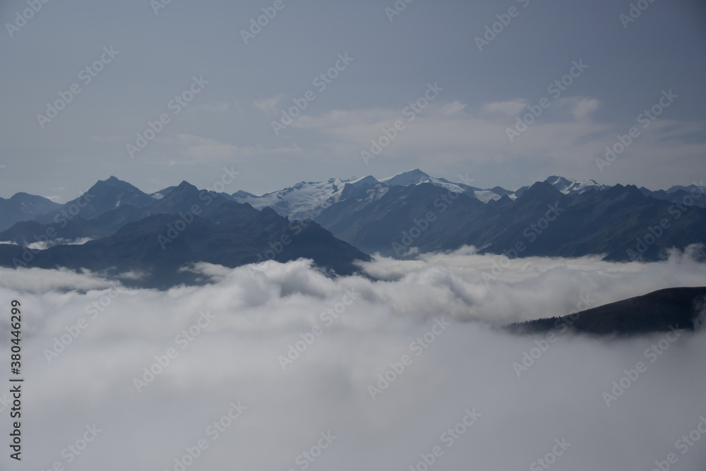 Mountain panorama of the Austrian Alps with low clouds