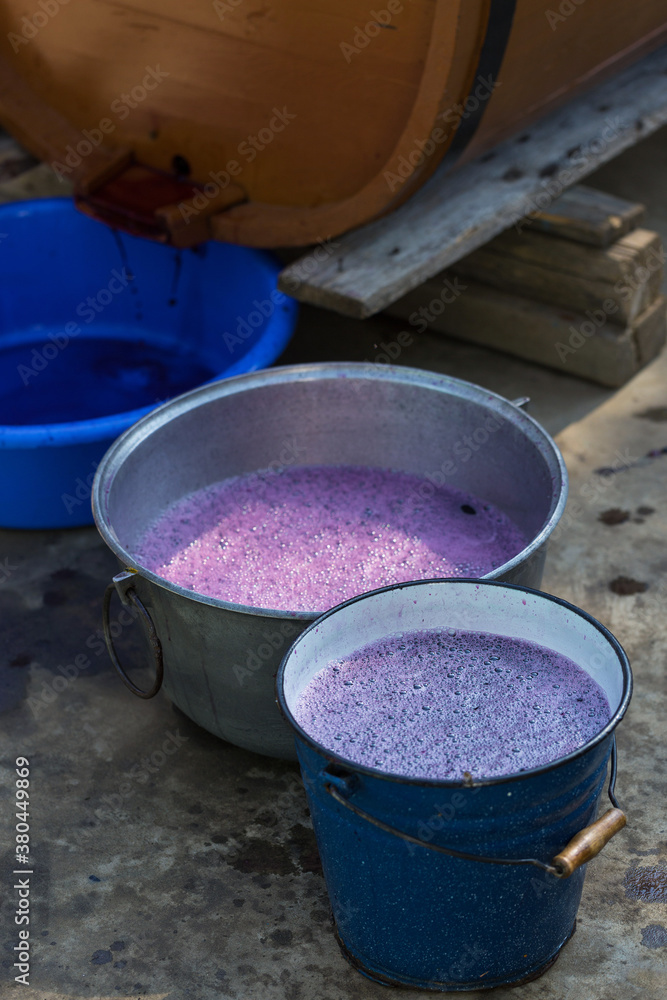 Grape juice close up during the autumn harvest. Traditional old technique of wine making. Filtering grape must. Grape juice close up during the autumn harvest. Traditional old technique of wine making. Filtering grape must.