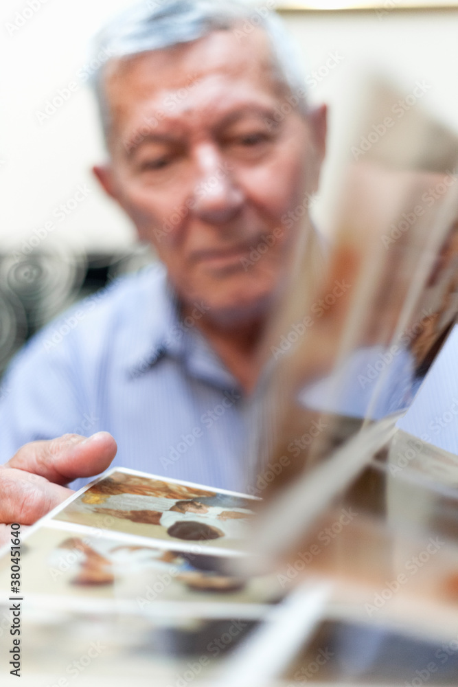 Senior man going trough old family photos