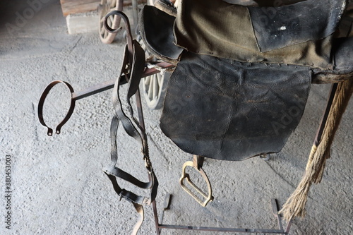 horse rustic saddle in rural stable