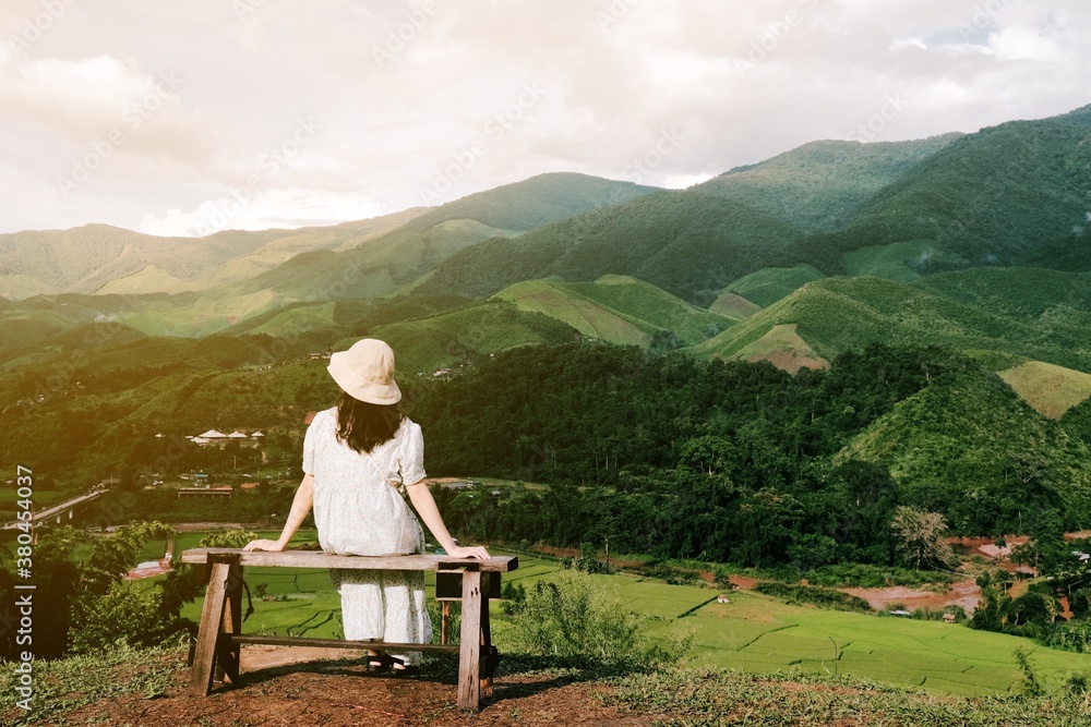 Asian female tourists travel in beautiful forests and mountains. Asian female tourists travel in beautiful forests and mountains.