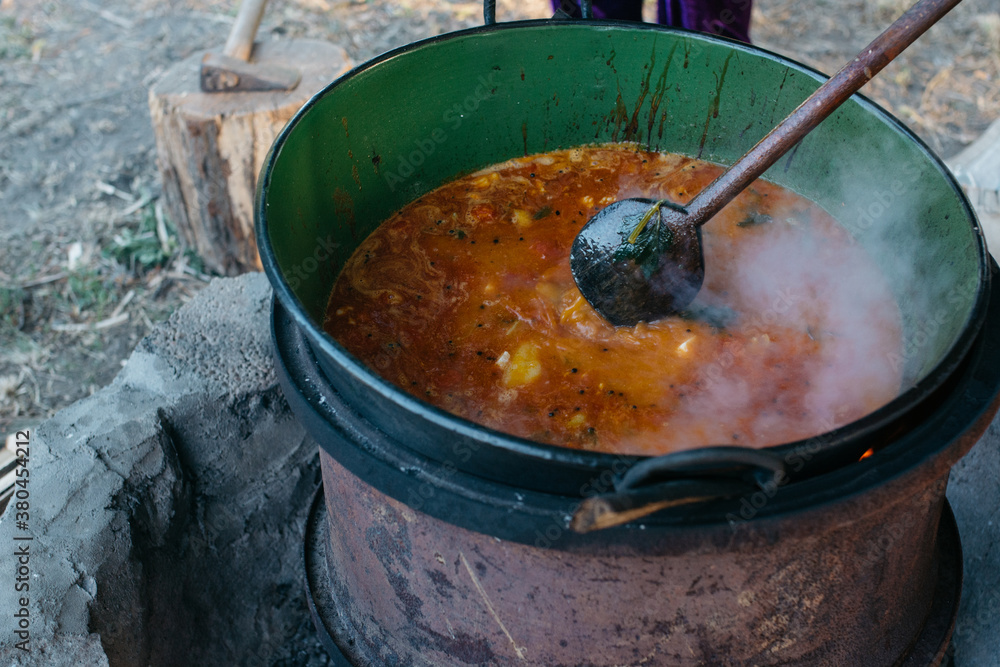 Traditional Hungarian goulash cooked over a fire Traditional Hungarian goulash cooked over a fire