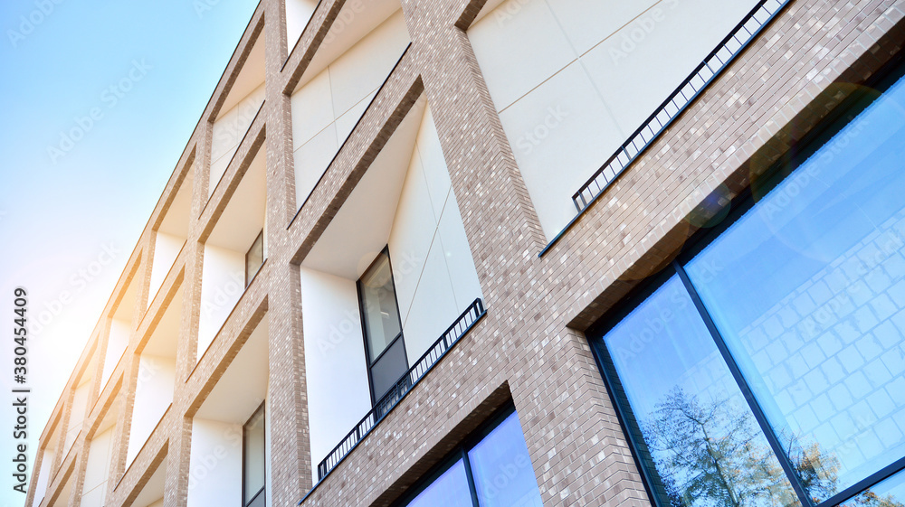 Architectural details of modern apartment building. Modern european residential apartment building complex with sunlight.