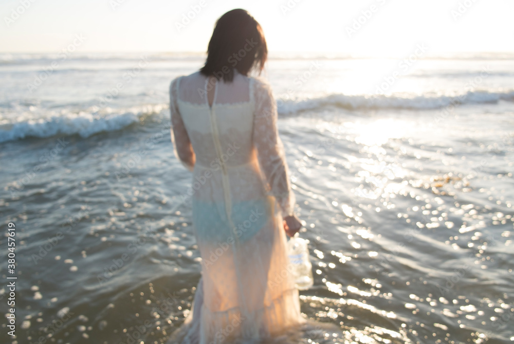 sad lady in wedding dress in the ocean water sad lady in wedding dress in the ocean water
