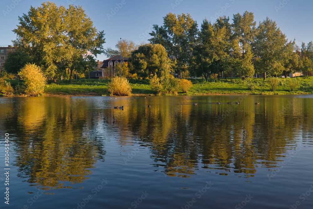Autumn landscape in a city park on the river bank. Autumn landscape in a city park on the river bank.