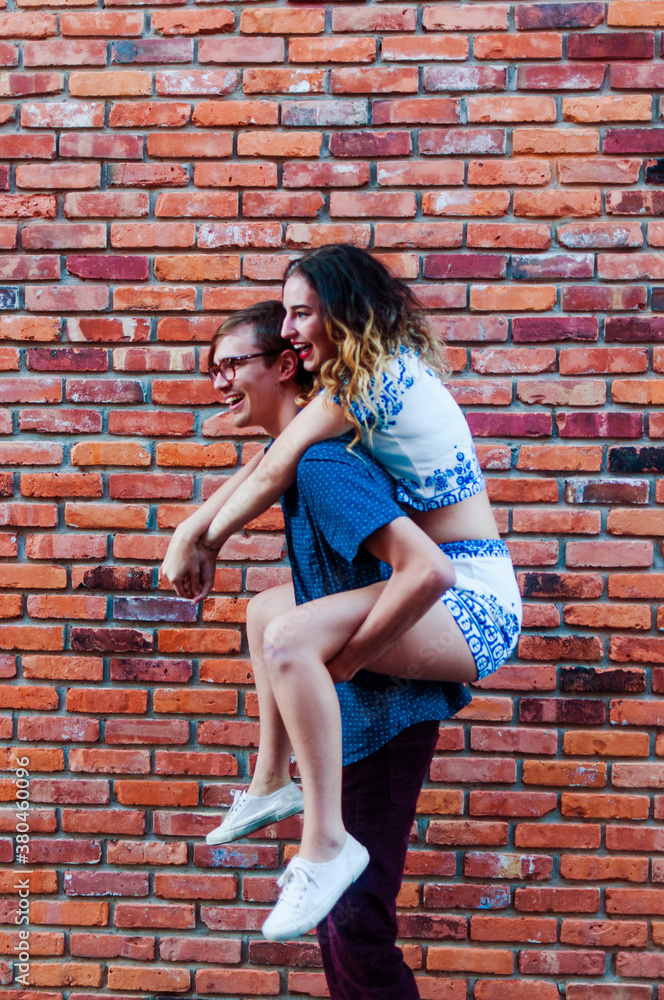 A young couple on a piggy back ride A young couple on a piggy back ride