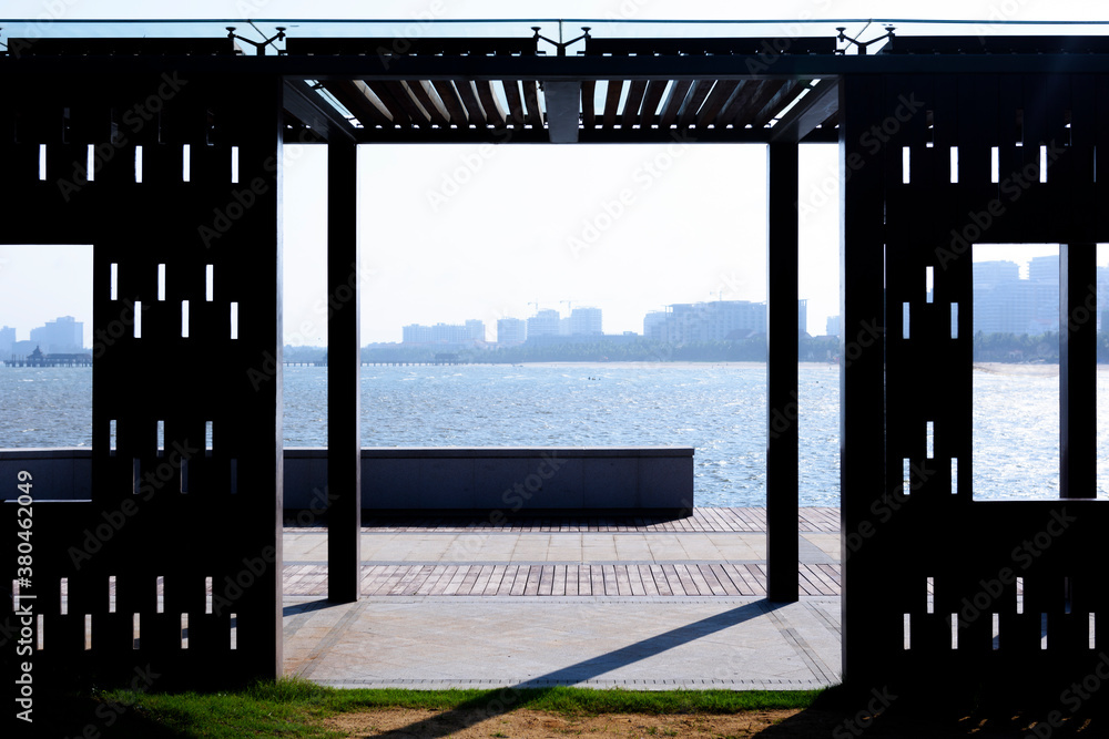 View of the sea on seashore through pavement in garden View of the sea on seashore through pavement in garden
