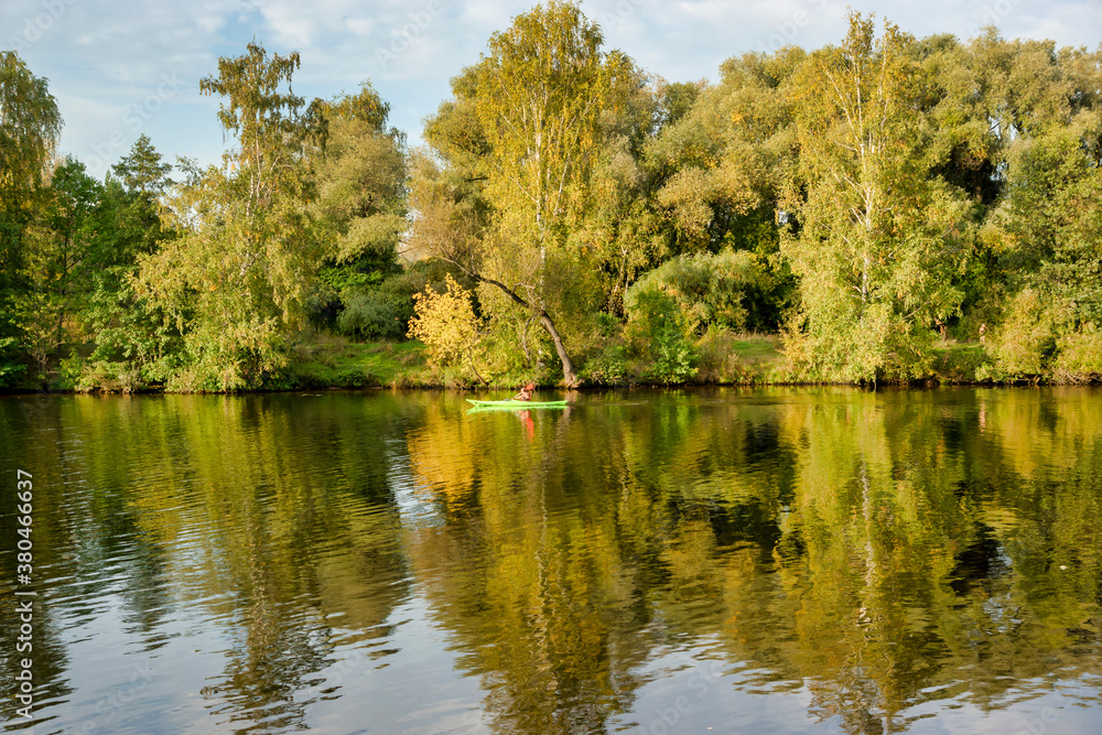 Sportsman kayaking on the river. Autumn landscape. Moscow river in Strogino, Moscow